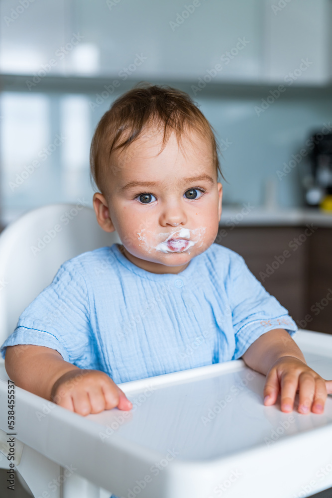 Young kid having breakfast. Cute little boy eating porridge. Young kid having breakfast. Cute little boy eating porridge.