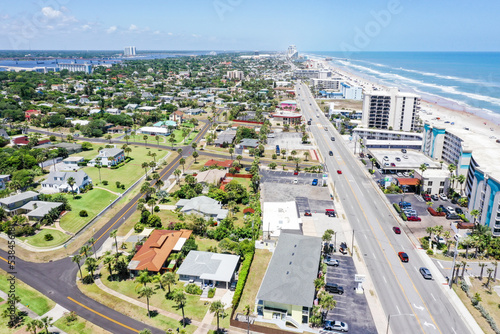 Aerial looking north over Daytona Beach, Florida residential neighborhoods and the Intracoastal Waterway. on the left and beachfront hotels and condos on the right.