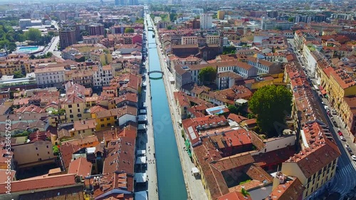 Aerial view of the water channels Navigli Milano and Porta Ticinese. Milano Darsena. Tourism. Public transport. Darsena freshwater canals in the city. Cars. Reflection. Milan Italy October 2022