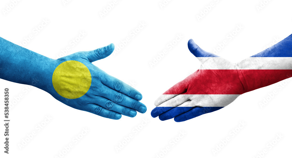 Handshake between Costa Rica and Palau flags painted on hands, isolated transparent image. Handshake between Costa Rica and Palau flags painted on hands, isolated transparent image.