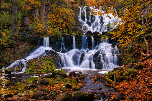 Beautiful waterfall in autumn forest in Jonkoping, Sweden. Long exposure.