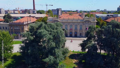 Aerial view of the cityscape and the main buildings of the Polytechnic University Interfacoltà PoliMi. Campus and library. Green lawns and trees. Students. Architecture. Milan Italy 03.2023