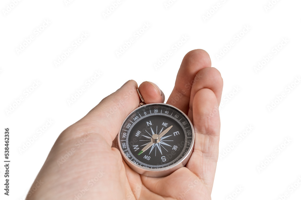 Man is holding compass in hand for navigation. Man is holding compass in hand for navigation.