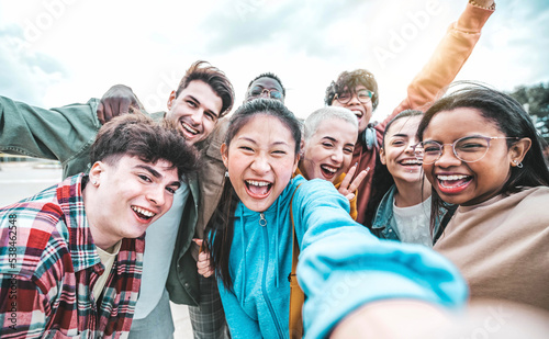 Photography Multiracial best friends taking selfie picture with smart mobile phone outside -