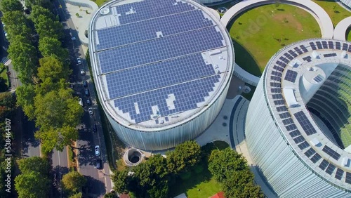 Aerial view of solar panels on the roof. The new campus of the SDA Bocconi School of Management is a modern building with classrooms. Autumn trees. Ecological energy. Milan Italy 11.2022 photo