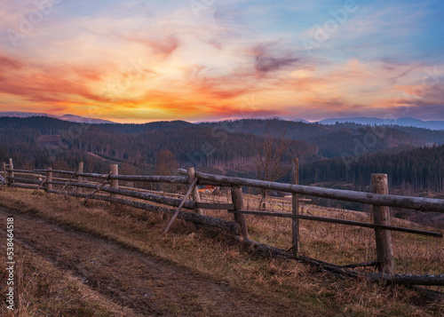 Picturesque pre sunrise morning above late autumn mountain countryside. Ukraine  Carpathian Mountains  Petros top in far. Peaceful traveling  seasonal  nature and countryside beauty concept scene.
