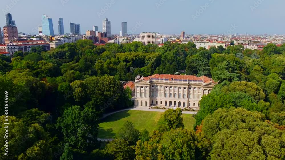 Aerial view of summer trees in Giardini Indro Montanelli park and skyline with new skyscrapers. View of modern business offices. Business. Tourism. Ecology. Clouds over the city. Green Planet. Milan. Aerial view of summer trees in Giardini Indro Montanelli park and skyline with new skyscrapers. View of modern business offices. Business. Tourism. Ecology. Clouds over the city. Green Planet. Milan.