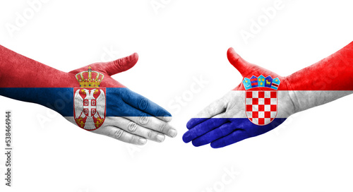 Handshake between Croatia and Serbia flags painted on hands, isolated transparent image.