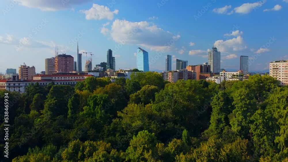 Aerial view of autumn trees in Giardini Indro Montanelli park and the skyline with new skyscrapers. View of modern business offices. Ecology. Clouds over the city. Green Planet. Milan. Italy, Aerial view of autumn trees in Giardini Indro Montanelli park and the skyline with new skyscrapers. View of modern business offices. Ecology. Clouds over the city. Green Planet. Milan. Italy,