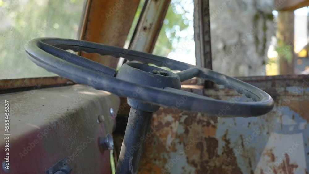 The steering wheel of the old truck abandoned inside the car garage in Estonia The steering wheel of the old truck abandoned inside the car garage in Estonia