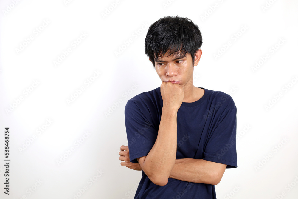 Sad, daydream, contemplating young asian man. Isolated on white background with copyspace Sad, daydream, contemplating young asian man. Isolated on white background with copyspace