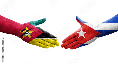 Handshake between Cuba and Mozambique flags painted on hands, isolated transparent image.