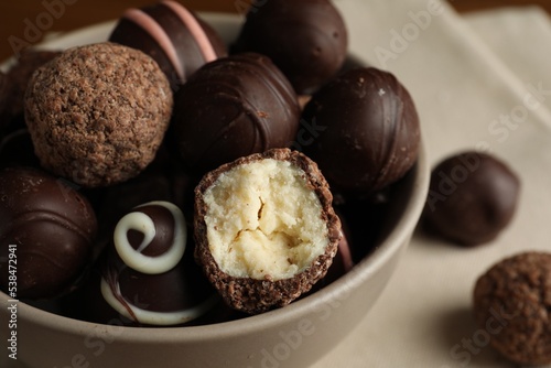 Bowl with many different delicious chocolate truffles, closeup