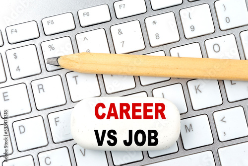 CAREER VS JOB text on eraser with pencil on keyboard