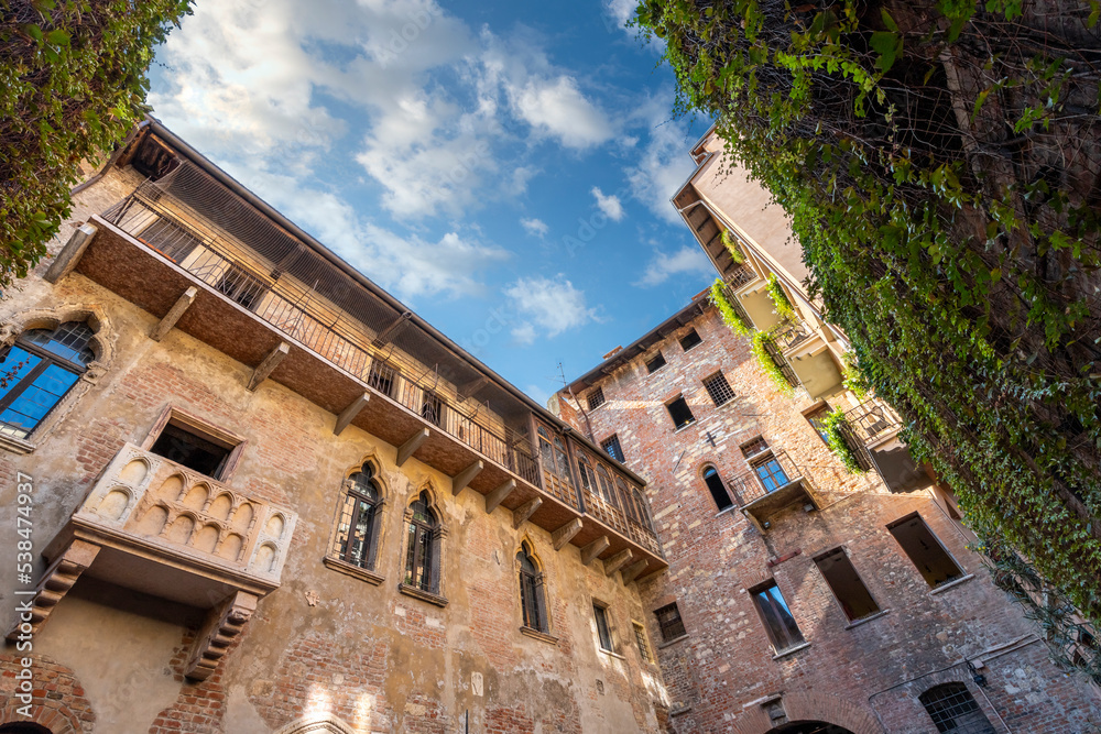 View of Juliet's balcony and house, a Gothic-style 1300s house and museum, with a stone balcony, said to have inspired Shakespeare, in Verona, Italy.