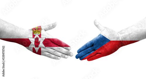 Handshake between Czechia and Northern Ireland flags painted on hands, isolated transparent image. photo