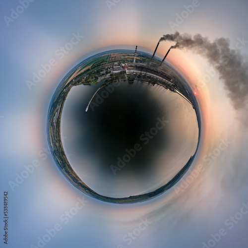 Fototapeta Naklejka Na Ścianę i Meble -  Aerial view from high altitude of little planet earth with coal power plant high pipes with black smokestack polluting atmosphere. Electricity production with fossil fuel concept