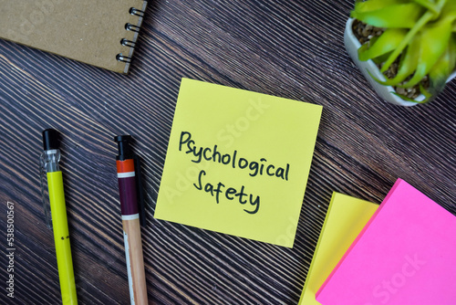 Concept of Psychological Safety write on sticky notes isolated on Wooden Table.
