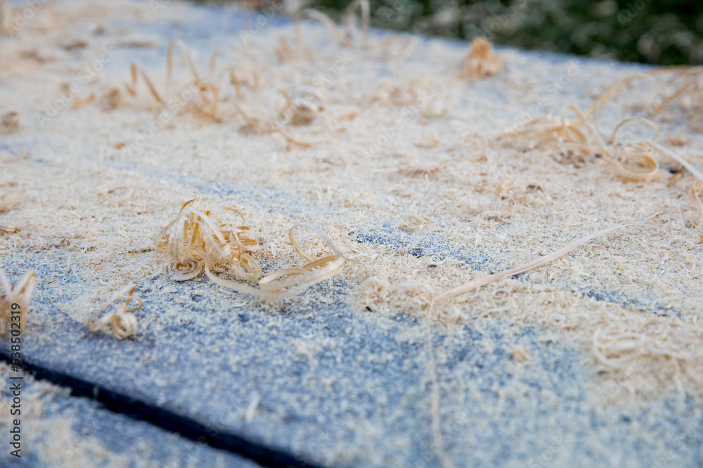 Woog shavings after planing beams and borders lying on gray wooden