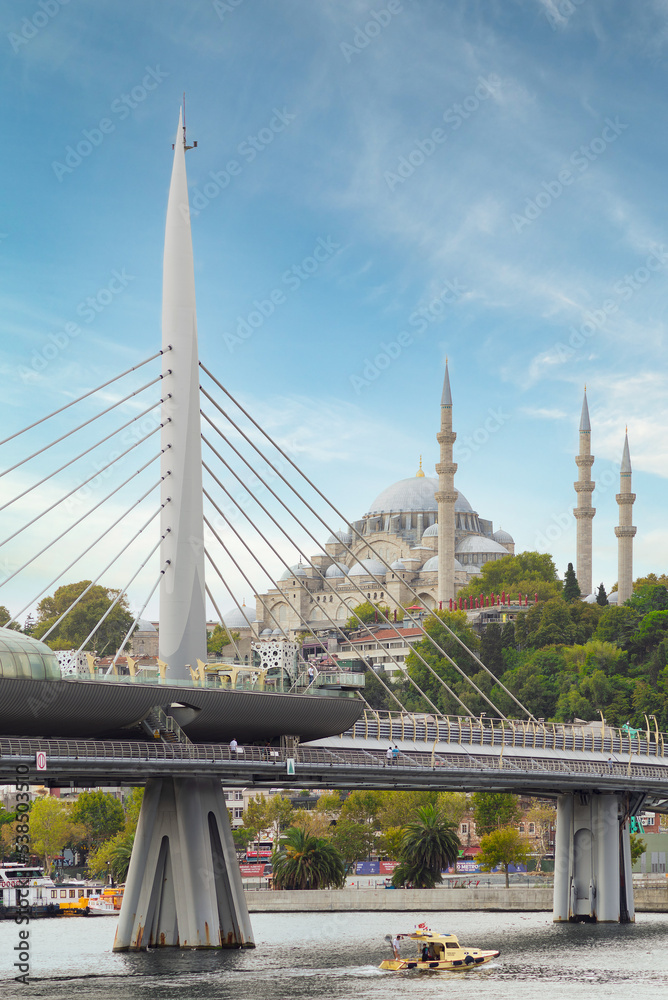 Day shot of Golden Horn Metro Bridge, or Halic Bridge, overlapping Suleymaniye Mosque, Istanbul, Turkey