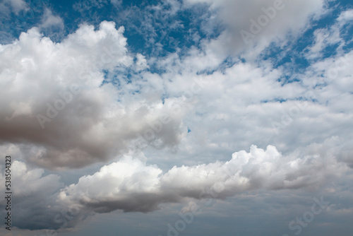 Fototapeta Naklejka Na Ścianę i Meble -  View of the blue sky with thick white clouds. Dense cumulus cloud cover.