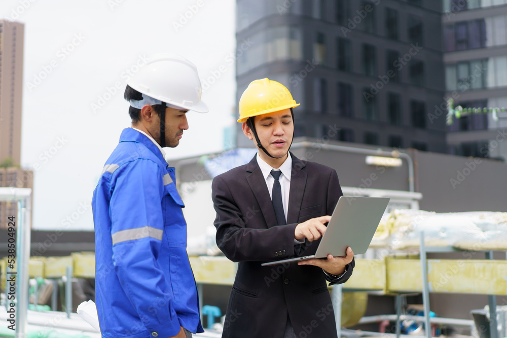 Senior manager and engineer - foreman inspecting or checking a building facilities on the building roof top. Senior manager and engineer - foreman inspecting or checking a building facilities on the building roof top.