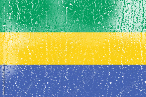 3D Flag of Gabon on a glass with water drop background.
