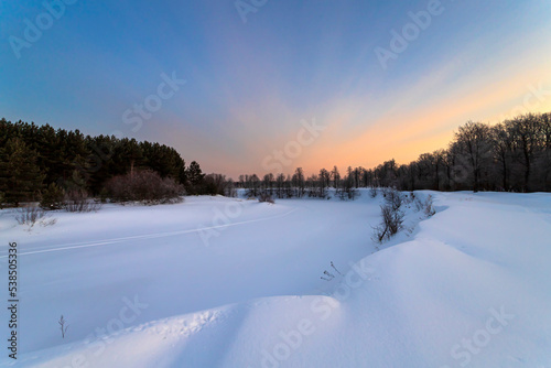 Frozen river at morning. Winter landscape.