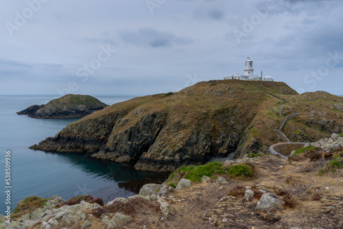 landscape view of the Pembrokeshire coast with the historic Strumble Head Lighthouse