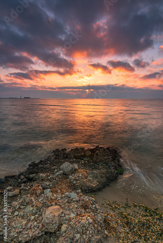 Sunrise on a rocky beach with amazing colors. God concept, end concept. Ebro Delta