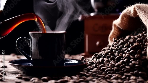 Coffee Cup, Coffee Beans, Natural Steam Smoke, Hot Drink. Close-up pouring hot coffee into black cup with real nature steam smoke with vintage grinder on dark background, 4K. Food and Drink Concepts