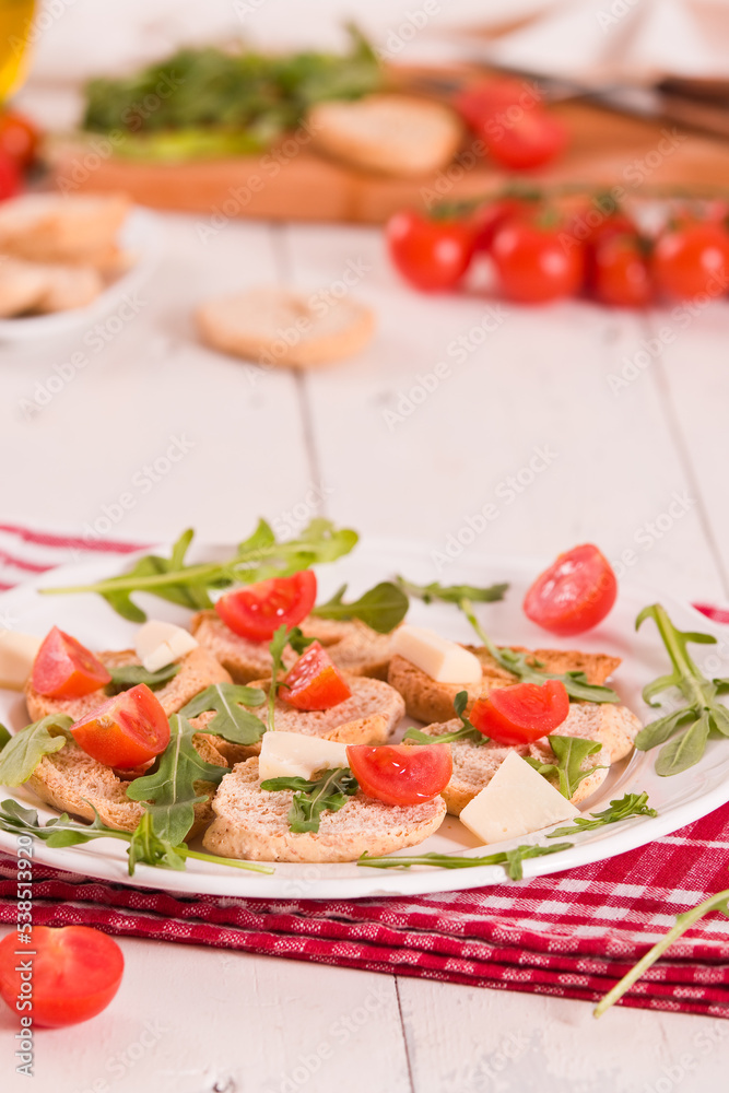 Friselle with cherry tomatoes and arugula. Friselle with cherry tomatoes and arugula.