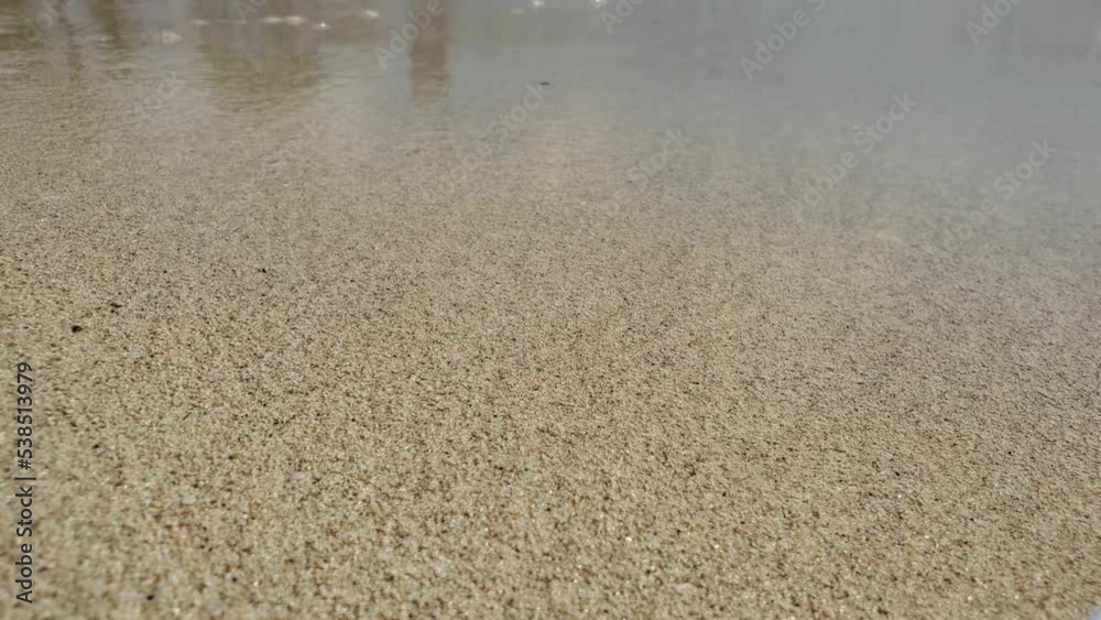 White sea sand closeup background. Sea water and white sand. White sea sand closeup background. Sea water and white sand.