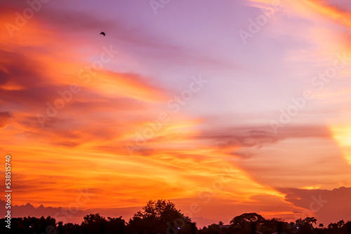 Dramatic sunset sky above clouds.  orange sunset sky. Beautiful sky.Dramatic red yellow pastel color at sunset  © Parichart