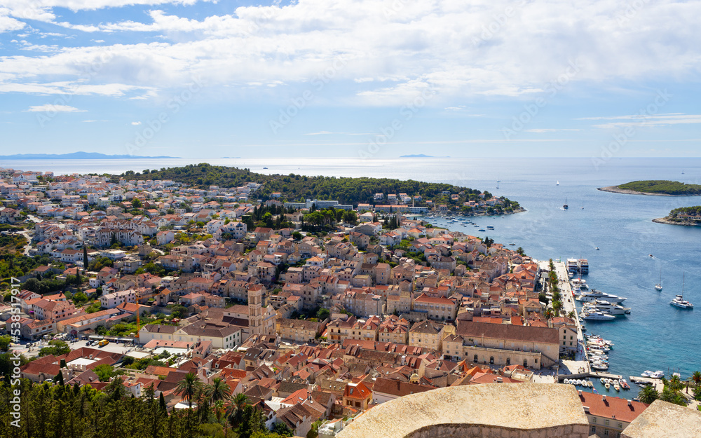 Fototapeta premium The town of Hvar on the Hvar island in Dalmatia, Croatia as seen from the Spanish Fortress (Tvrdava Fortica), with the Adriatic sea in the background.