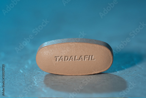 Tadalafil drug Pill Medication ob blue background photo