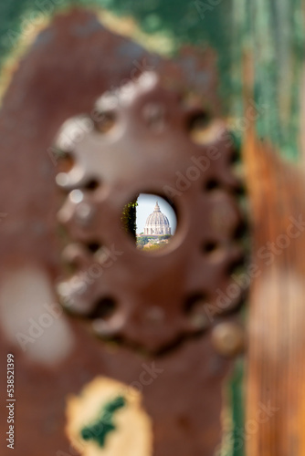 View of St. Peter's basilica dome in Vatican through keyhole at Knights of Malta square, Rome, Italy photo