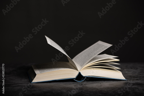 Composition of an open book on a dark background