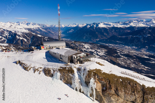 Anzere, Switzerland: Aerial view of the Anzere ski resort and summit cable car station in Canton Valais in the Swiss alps on a sunny winter day