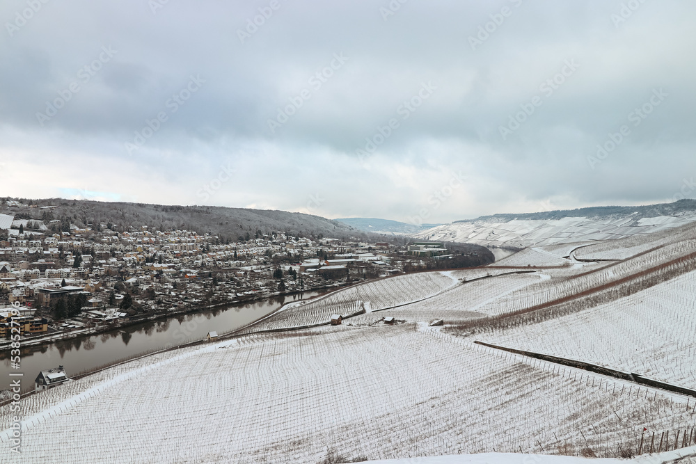 Enchanting aerial scenic view of the Mosel valley and the town of Bernkastel-kues Germany covered in snow during winter 