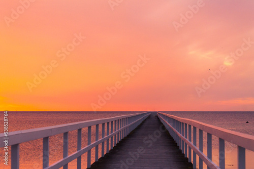 Beautiful sunset over the sea with wooden pier