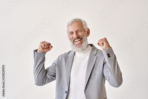Happy excited rich successful old senior professional business man leader investor winner raising fists isolated on white background celebrating success victory, rejoicing work achievements.