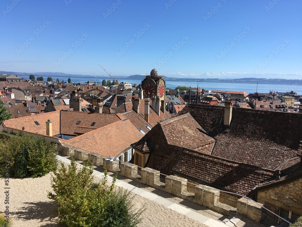 Historical old colourful buildings. Cityscape of colourful red brick old houses and buildings. Old rooftops cityscape from red bricks tiles on the top. Summer day travel city view in Switzerland alley