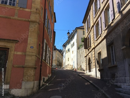 Historical old colourful buildings. Cityscape of colourful red brick old houses and buildings. Old rooftops cityscape from red bricks tiles on the top. Summer day travel city view in Switzerland alley