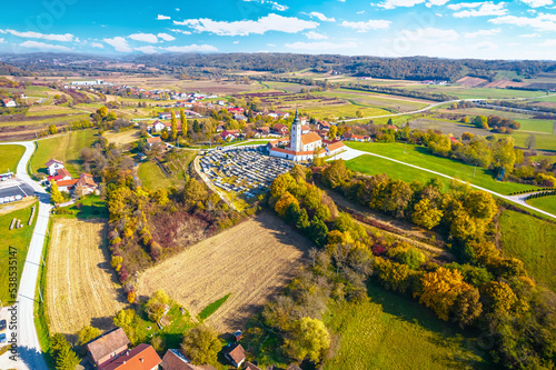 Village of Komin church and green landscape aerial view photo