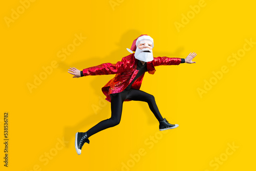 Man with funny Santa Claus low poly origami mask on colored background, colorful costume for Christmas holiday
