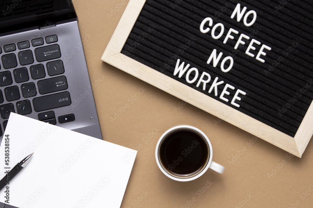 Top view of cup of black coffee and phrase No coffee No workee on letter board. Top view of cup of black coffee and phrase No coffee No workee on letter board.