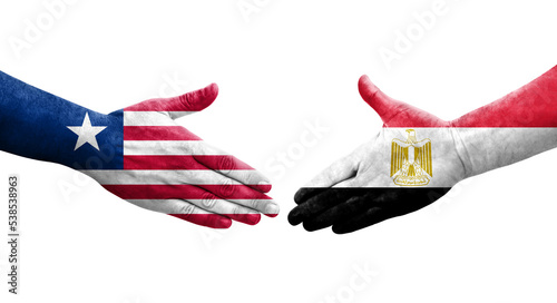 Handshake between Egypt and Liberia flags painted on hands, isolated transparent image.