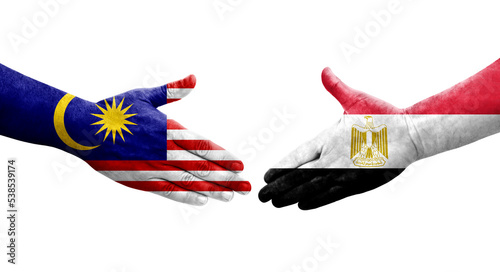 Handshake between Egypt and Malaysia flags painted on hands, isolated transparent image.