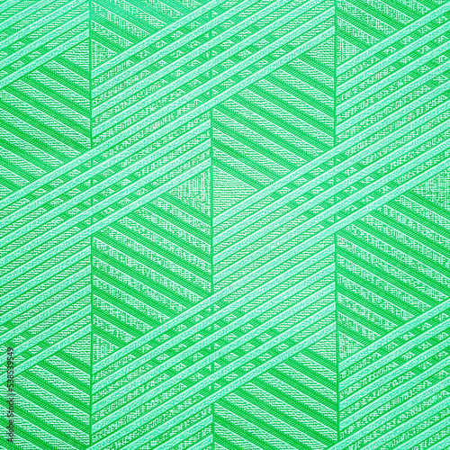 Green ceramic tile with geometric pattern for wall and floor decoration. Concrete stone surface background. Texture with simple rhombuses ornament  for interior design project.